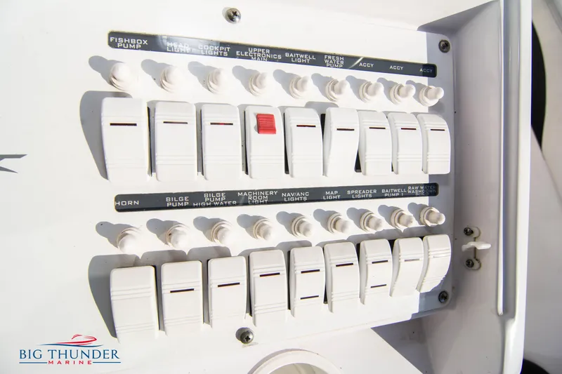 Slide: The Image of Control panel of a 2005 Donzi 32 ZF boat with labeled switches. - 35