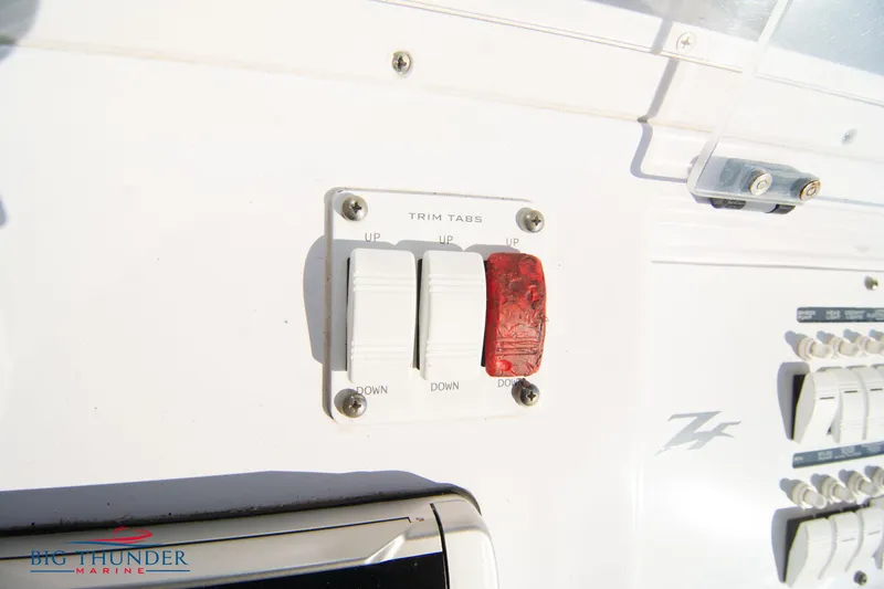 Slide: The Image of Trim tab controls on a 2005 Donzi 32 ZF boat dashboard. - 36