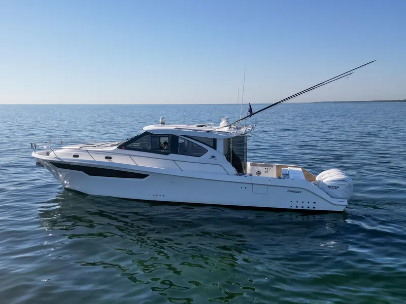 Slide: The Image of 2024 Pursuit OS 445 Offshore boat on calm sea. - 23