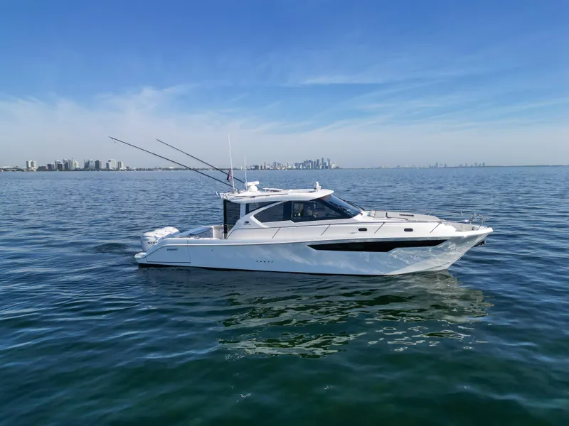 Slide: The Image of 2024 Pursuit OS 445 Offshore boat cruising on calm ocean waters. - 28