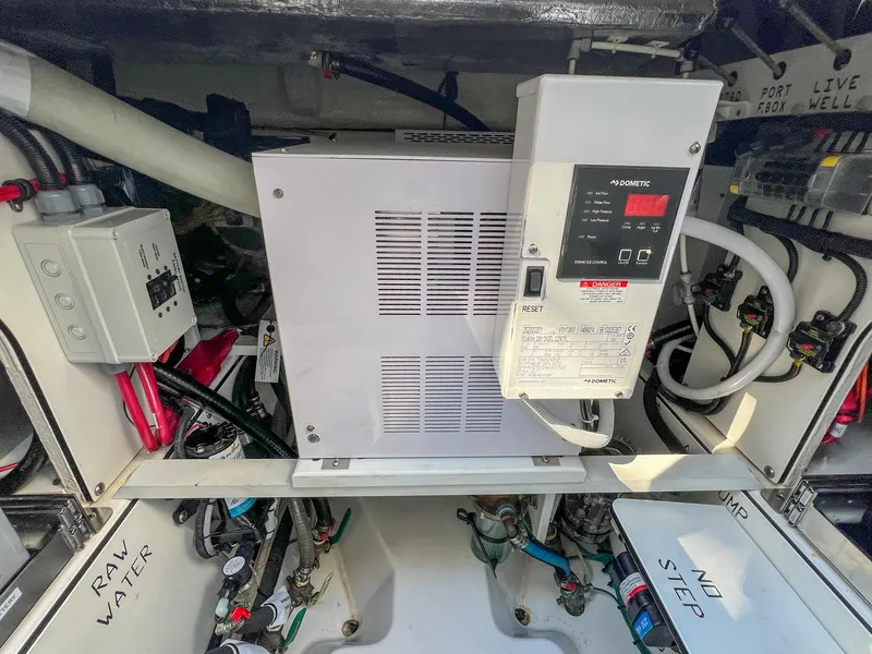 Slide: The Image of 2024 Pursuit OS 445 Offshore engine compartment with electrical components and wiring. - 32