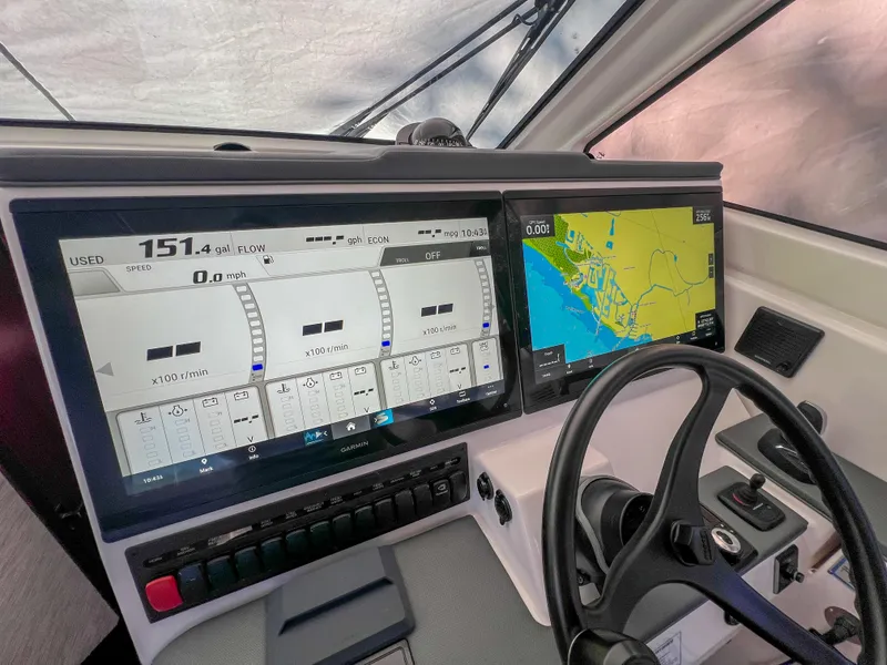 Slide: The Image of 2024 Pursuit OS 445 Offshore dashboard with navigation and control screens. - 33
