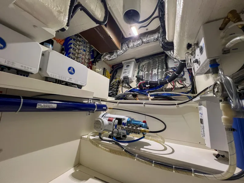 Slide: The Image of Engine room of 2024 Pursuit OS 445 Offshore boat, showcasing advanced wiring and equipment. - 37