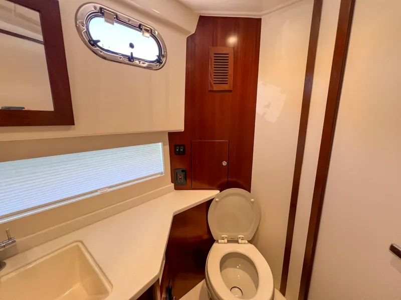 Slide: The Image of 2024 Pursuit OS 445 Offshore yacht bathroom with modern fixtures and wooden accents. - 41