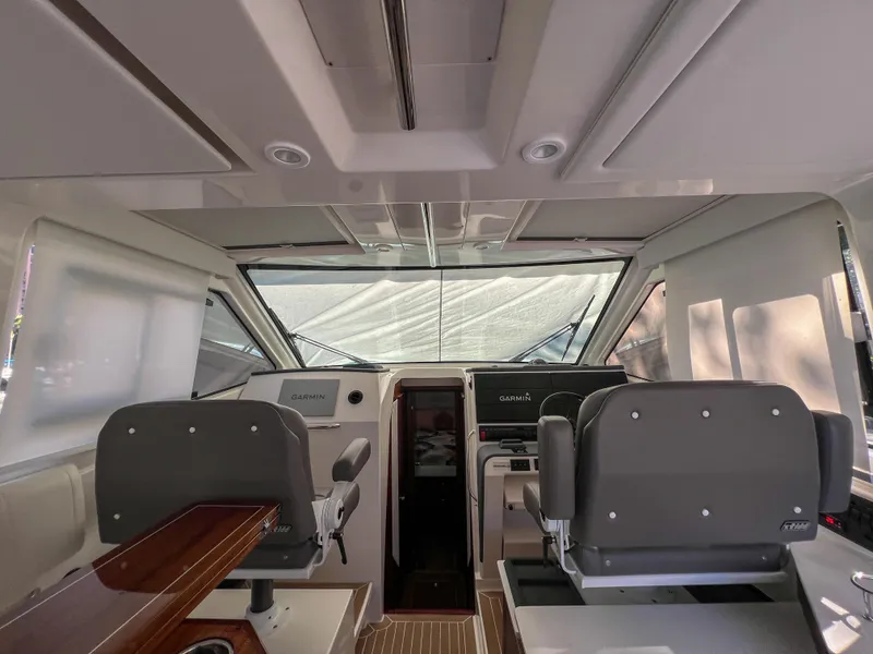 Slide: The Image of 2024 Pursuit OS 445 Offshore boat interior with modern helm and seating. - 42