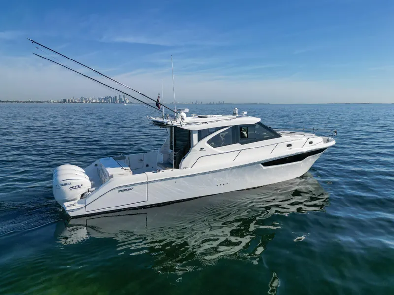 Slide: The Image of 2024 Pursuit OS 445 Offshore boat on calm water, city skyline in background. - 8