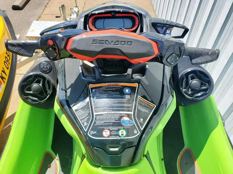 Slide: The Image of 2021 Sea-Doo RXT handlebars and dashboard, featuring control buttons and safety instructions. - 10