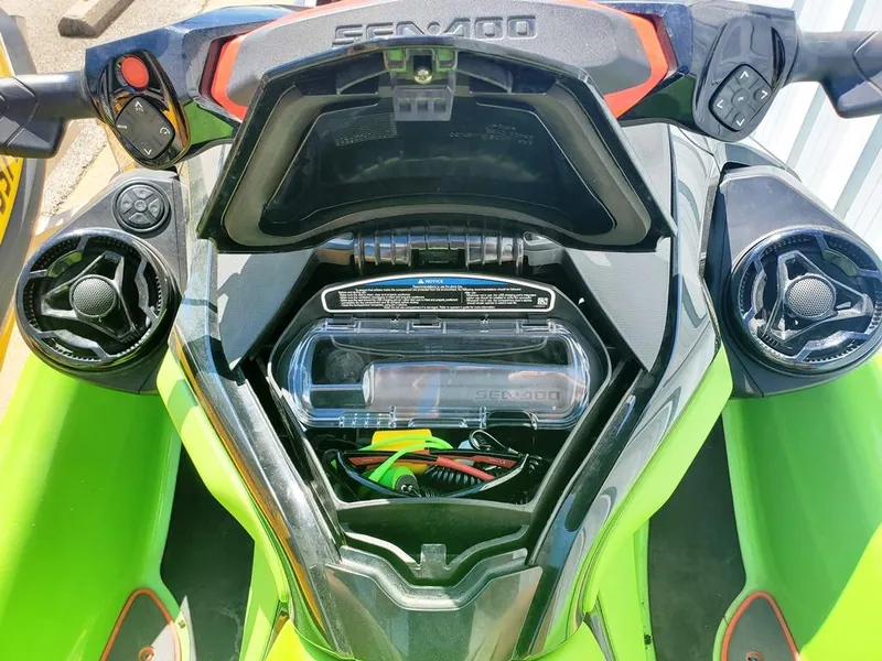 Slide: The Image of 2021 Sea-Doo RXT storage compartment with open lid, showcasing internal components. - 11