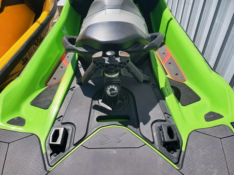 Slide: The Image of 2021 Sea-Doo RXT green and black jet ski interior with handlebars and seat. - 16