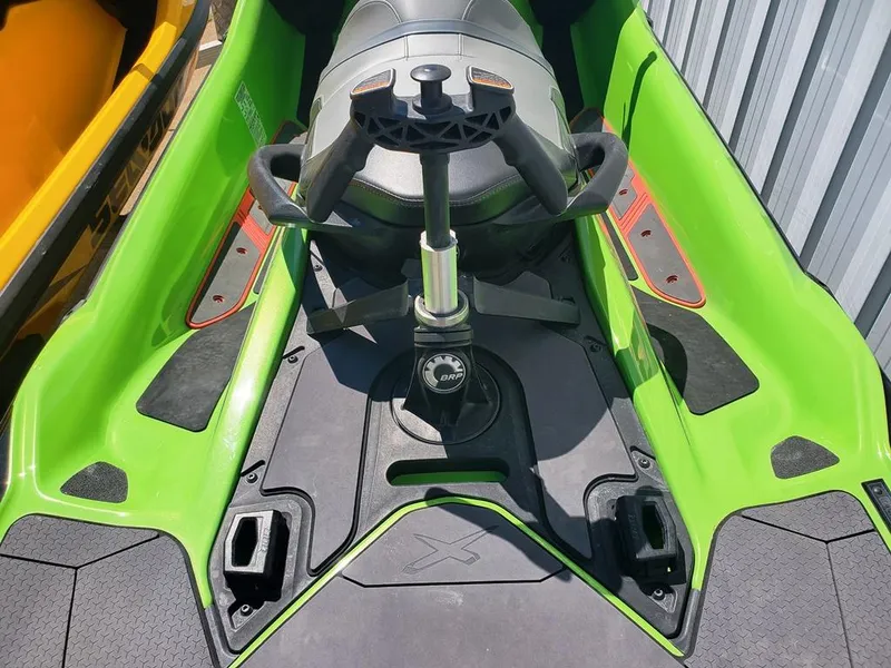 Slide: The Image of 2021 Sea-Doo RXT green jet ski cockpit with handlebars and seat. - 17