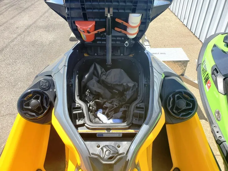Slide: The Image of 2021 Sea-Doo RXT storage compartment open, showing interior and safety equipment. - 6