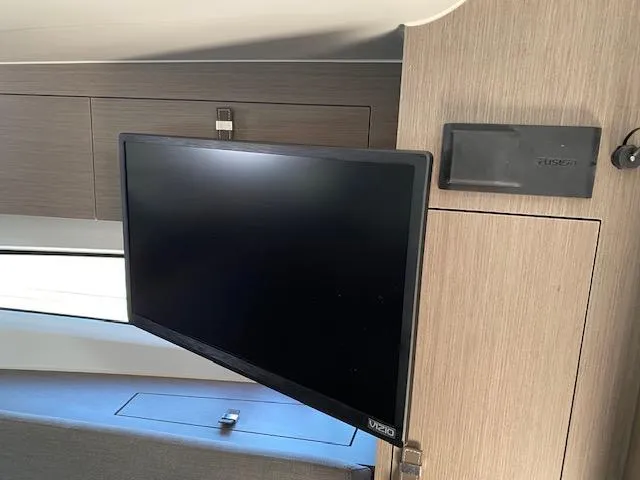Slide: The Image of 2024 Beneteau Gran Turismo 32 interior with mounted Vizio TV and Fusion audio system. - 11