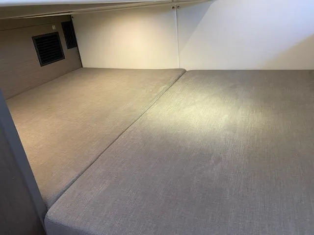Slide: The Image of 2024 Beneteau Gran Turismo 32 cabin interior with gray bedding. - 13