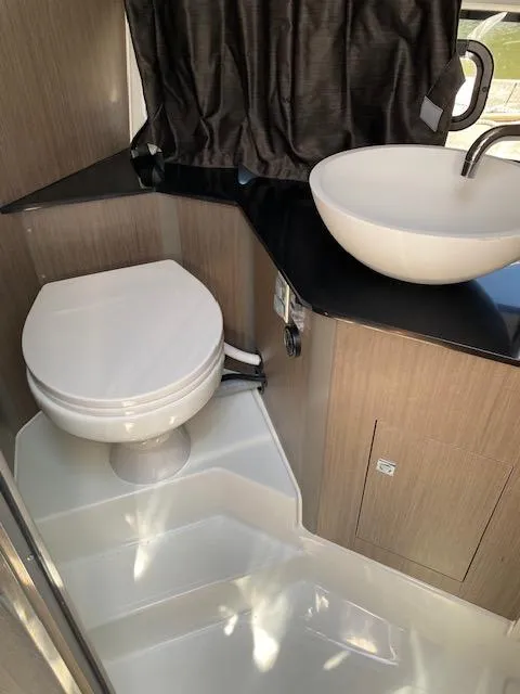 Slide: The Image of 2024 Beneteau Gran Turismo 32 bathroom with modern sink and toilet. - 14