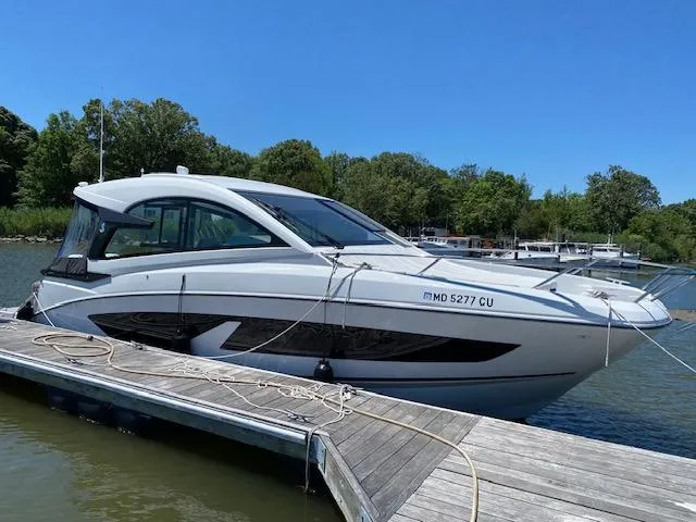 Slide: The Image of 2024 Beneteau Gran Turismo 32 yacht docked on a sunny day. - 2