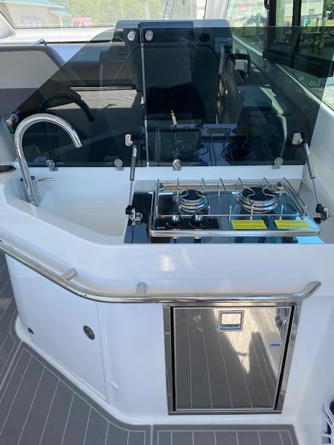 Slide: The Image of 2024 Beneteau Gran Turismo 32 yacht kitchen with stove, sink, and storage. - 7