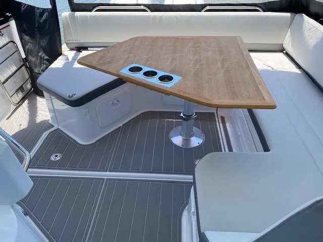 Slide: The Image of 2024 Beneteau Gran Turismo 32 interior with sleek seating and wooden table. - 9