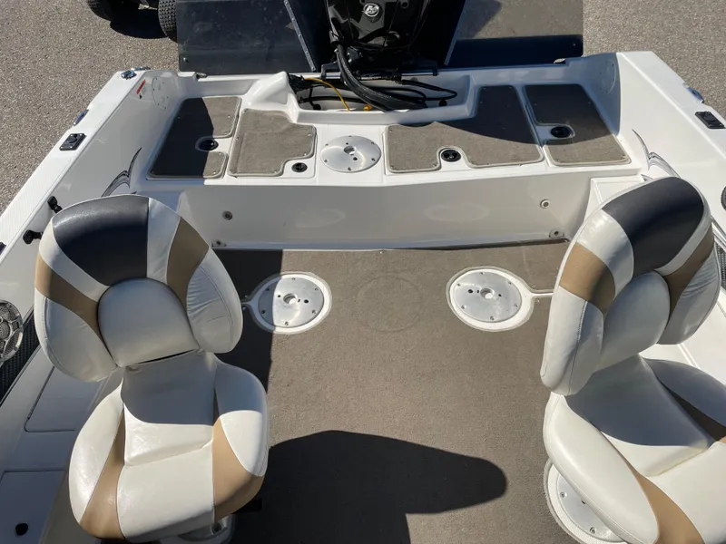 Slide: The Image of 2012 Larson FX 1750 DC boat interior with two seats and storage compartments. - 10