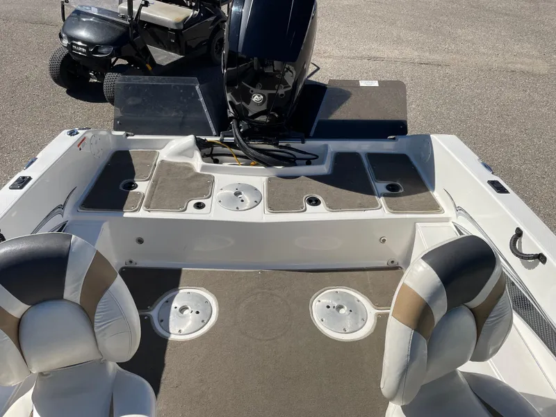 Slide: The Image of 2012 Larson FX 1750 DC boat interior with seating and storage compartments. - 11