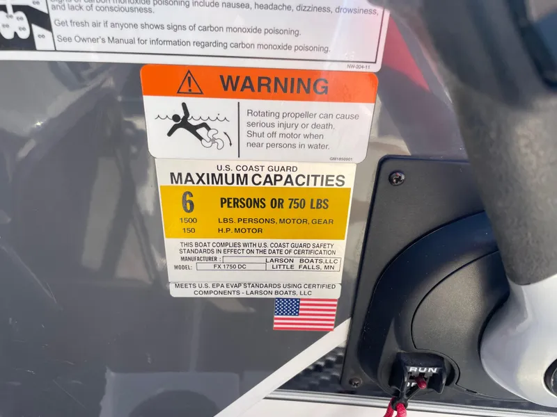 Slide: The Image of 2012 Larson FX 1750 DC boat warning and capacity label, 6 persons or 750 lbs max. - 12