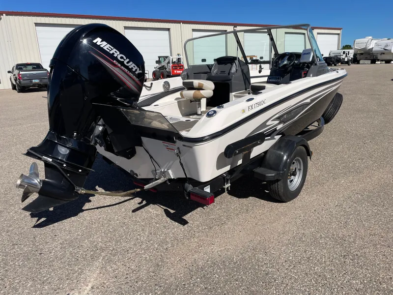 Slide: The Image of 2012 Larson FX 1750 DC boat with Mercury outboard motor in a parking lot. - 3