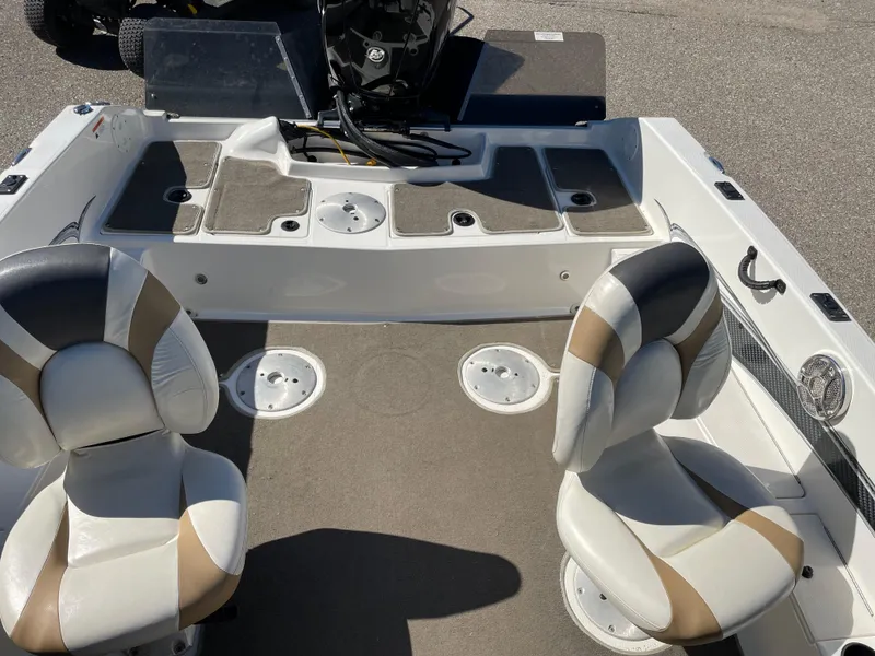 Slide: The Image of 2012 Larson FX 1750 DC boat interior with two seats and storage compartments. - 6