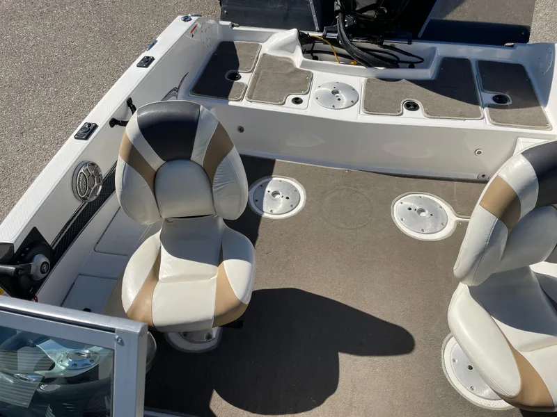 Slide: The Image of 2012 Larson FX 1750 DC boat interior with two swivel seats and storage compartments. - 8