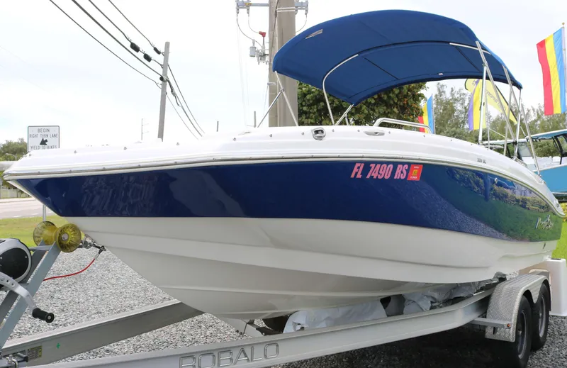 The Image of 2018 NauticStar 203 SC boat on trailer with blue canopy and registration number. - 0