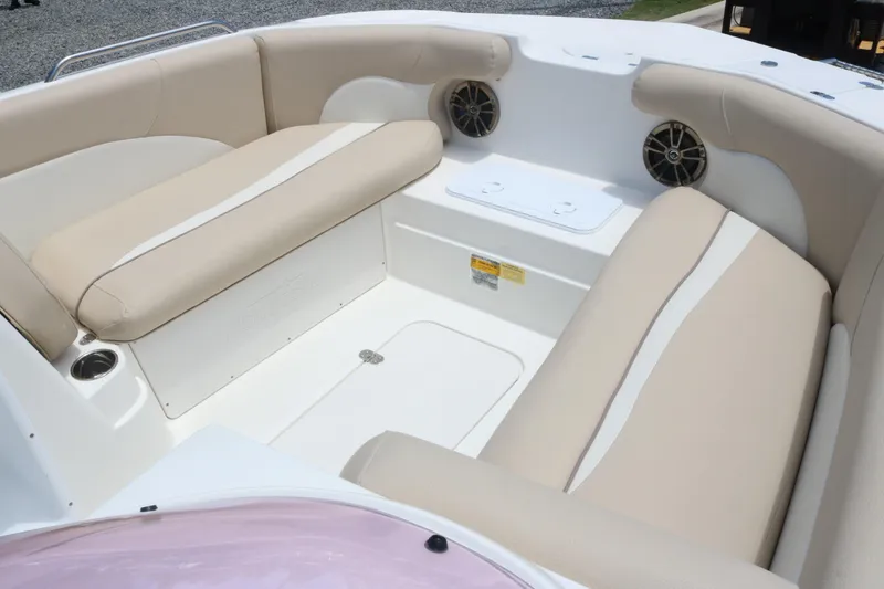 Slide: The Image of 2018 NauticStar 203 SC boat interior with beige seating and built-in speakers. - 10
