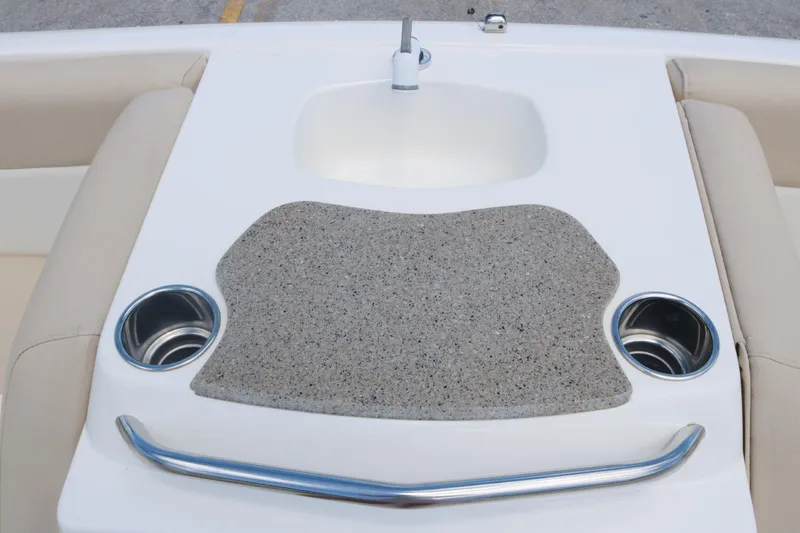 Slide: The Image of 2018 NauticStar 203 SC boat sink and countertop with cup holders. - 12