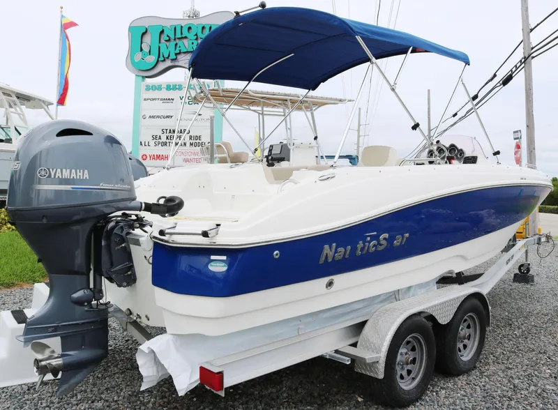 Slide: The Image of 2018 NauticStar 203 SC boat with Yamaha engine on a trailer. - 3