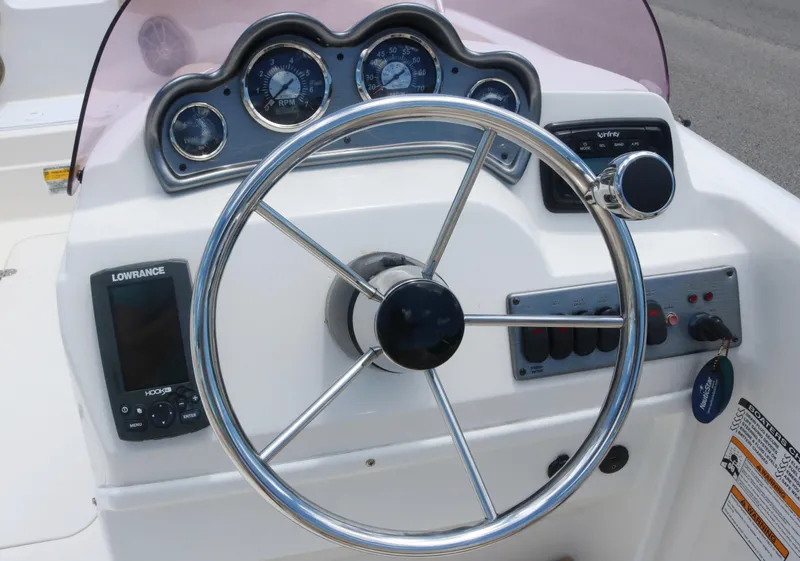 Slide: The Image of 2018 NauticStar 203 SC boat dashboard with steering wheel and navigation instruments. - 7