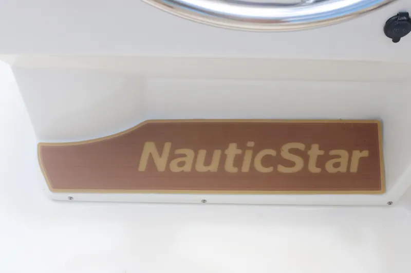 Slide: The Image of 2018 NauticStar 203 SC boat logo on wooden panel. - 9