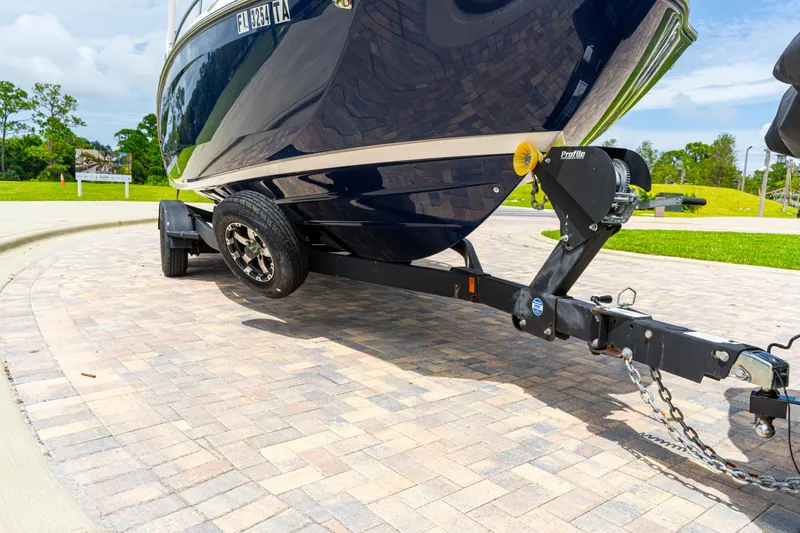 Slide: The Image of 2021 Yamaha Boats 252S on trailer, parked on paved surface. - 11