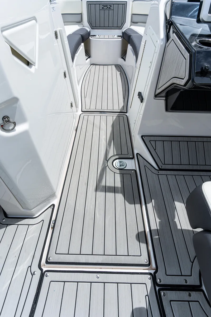 Slide: The Image of 2021 Yamaha Boats 252S interior with sleek, modern deck design and seating area. - 27
