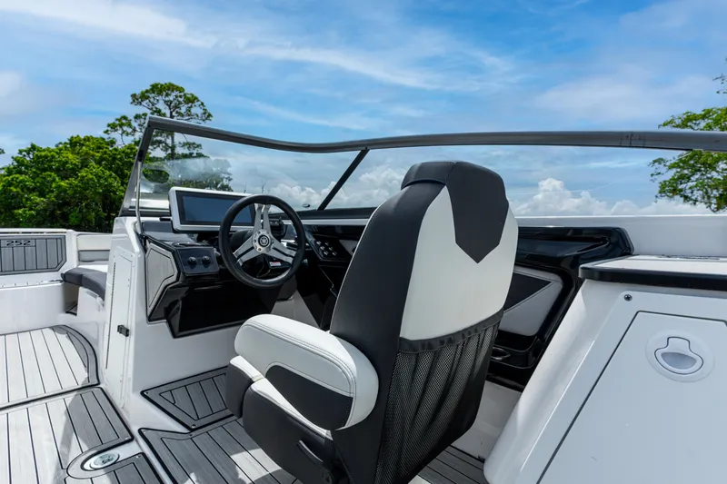 Slide: The Image of 2021 Yamaha Boats 252S cockpit with sleek design and modern controls under a clear blue sky. - 29