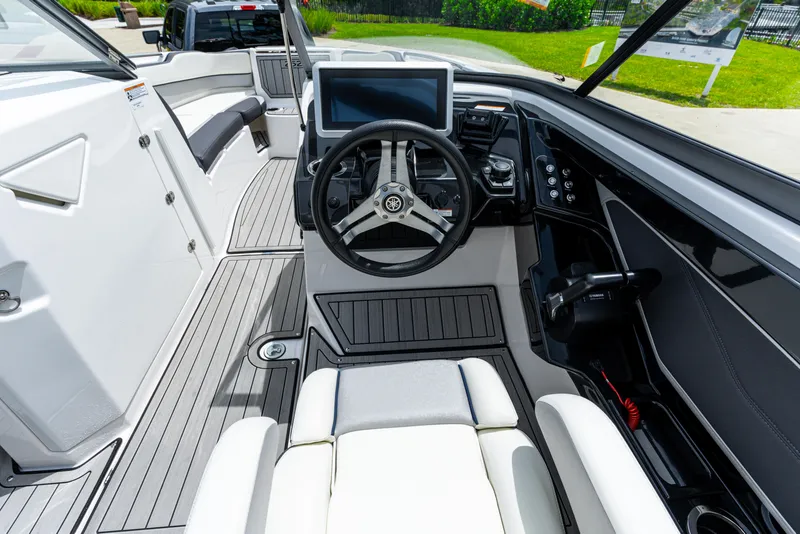 Slide: The Image of Interior view of 2021 Yamaha Boats 252S, featuring sleek dashboard and steering wheel. - 30