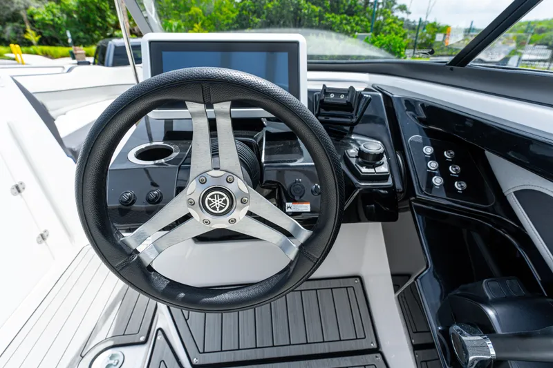 Slide: The Image of 2021 Yamaha Boats 252S steering wheel and dashboard, featuring modern controls and sleek design. - 31