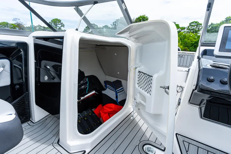 Slide: The Image of 2021 Yamaha Boats 252S storage compartment with gear and accessories. - 39