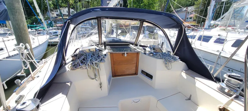 Slide: The Image of 1988 Sabre 38 MkII sailboat cockpit with blue canvas cover and docked at marina. - 13