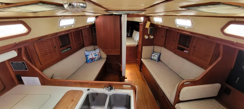 Slide: The Image of 1988 Sabre 38 MkII sailboat interior with cozy seating and wooden finishes. - 16