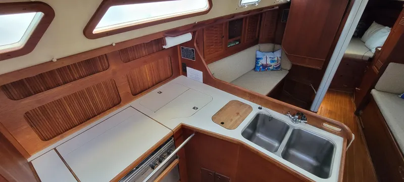 Slide: The Image of 1988 Sabre 38 MkII yacht interior with kitchen and seating area. - 18
