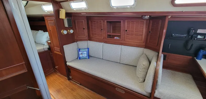 Slide: The Image of Interior of 1988 Sabre 38 MkII sailboat with wooden cabinetry and cushioned seating. - 19