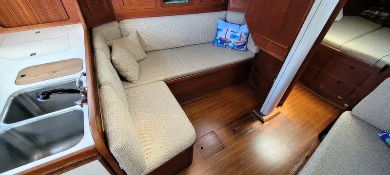 Slide: The Image of Interior of 1988 Sabre 38 MkII sailboat with cozy seating and kitchen area. - 20