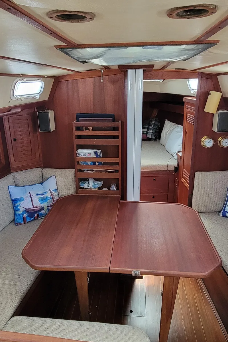 Slide: The Image of Interior of 1988 Sabre 38 MkII sailboat with wooden dining table and cozy seating. - 21