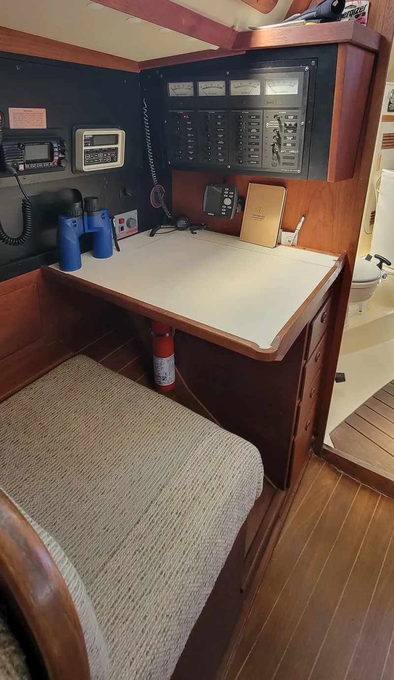 Slide: The Image of Navigation station on a 1988 Sabre 38 MkII sailboat with control panels and equipment. - 23