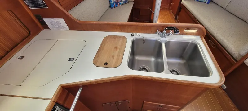Slide: The Image of 1988 Sabre 38 MkII yacht galley with double sink and wooden countertops. - 26