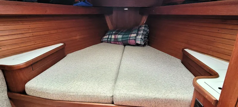 Slide: The Image of 1988 Sabre 38 MkII V-berth cabin with cushions and plaid pillow. - 27