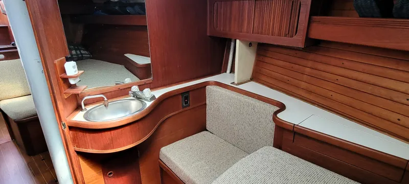 Slide: The Image of 1988 Sabre 38 MkII yacht interior with sink, seating, and wooden cabinetry. - 28