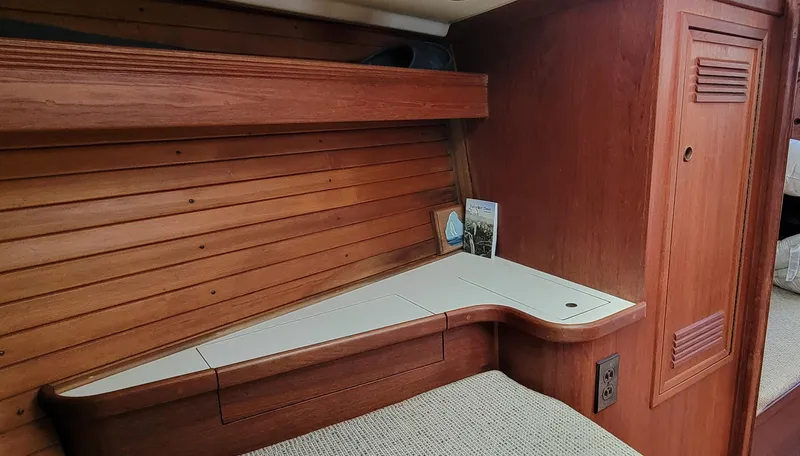 Slide: The Image of Interior cabin of 1988 Sabre 38 MkII sailboat with wooden paneling and desk. - 29